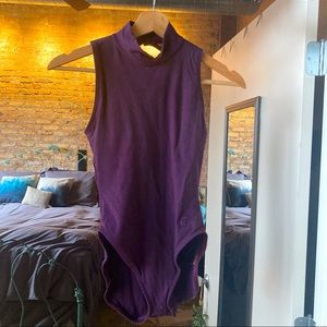 Purple sleeveless turtleneck bodysuit.